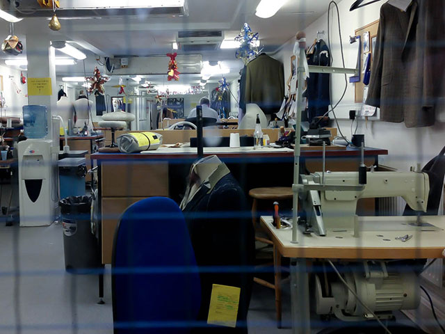 Savile Row Tailor at work in his workshop. Photo by alphacityguides.